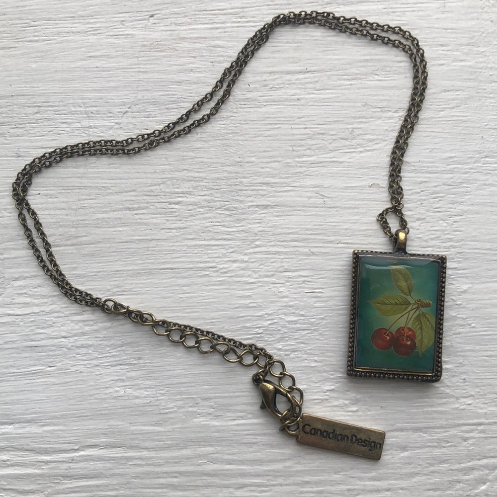 Whimsical pendant necklace featuring deer, cherry
